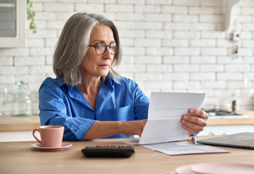 Senior mid 60s aged woman calculating bank fee wit 2026 01 08 00 20 03 utc