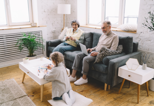 Smiling grandparents watching granddaughter