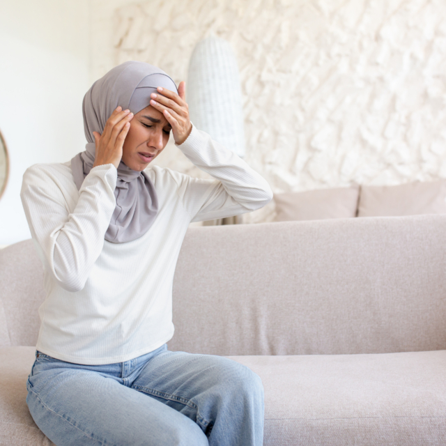 A young woman in a hijab is sitting on the sofa at 2023 11 27 05 21 26 utc