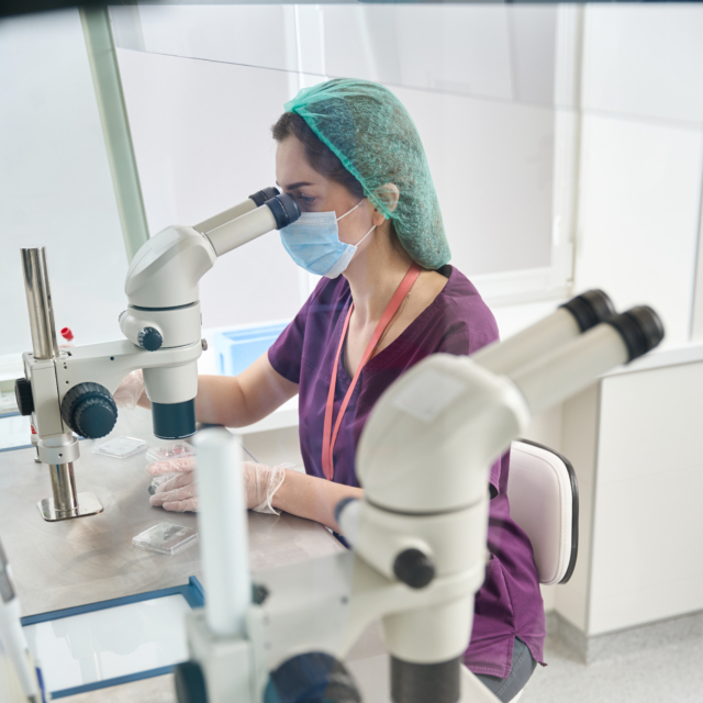 Woman in overalls looks into eyepiece of a powerfu 2023 11 27 04 50 58 utc